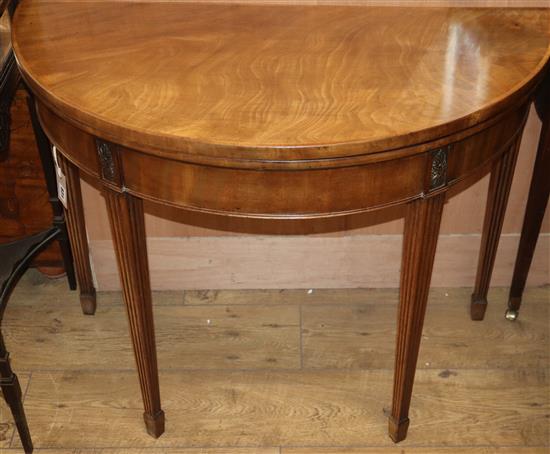 A George III mahogany demi lune card table W.91cm